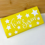Milk chocolate bar wrapped in yellow patterned paper featuring the words 'you're a star' in Welsh - Ti'n seren