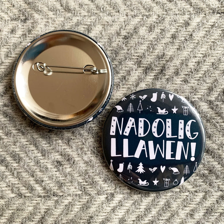 Handmade navy Welsh badge featuring the words Nadolig Llawen and Christmas icons
