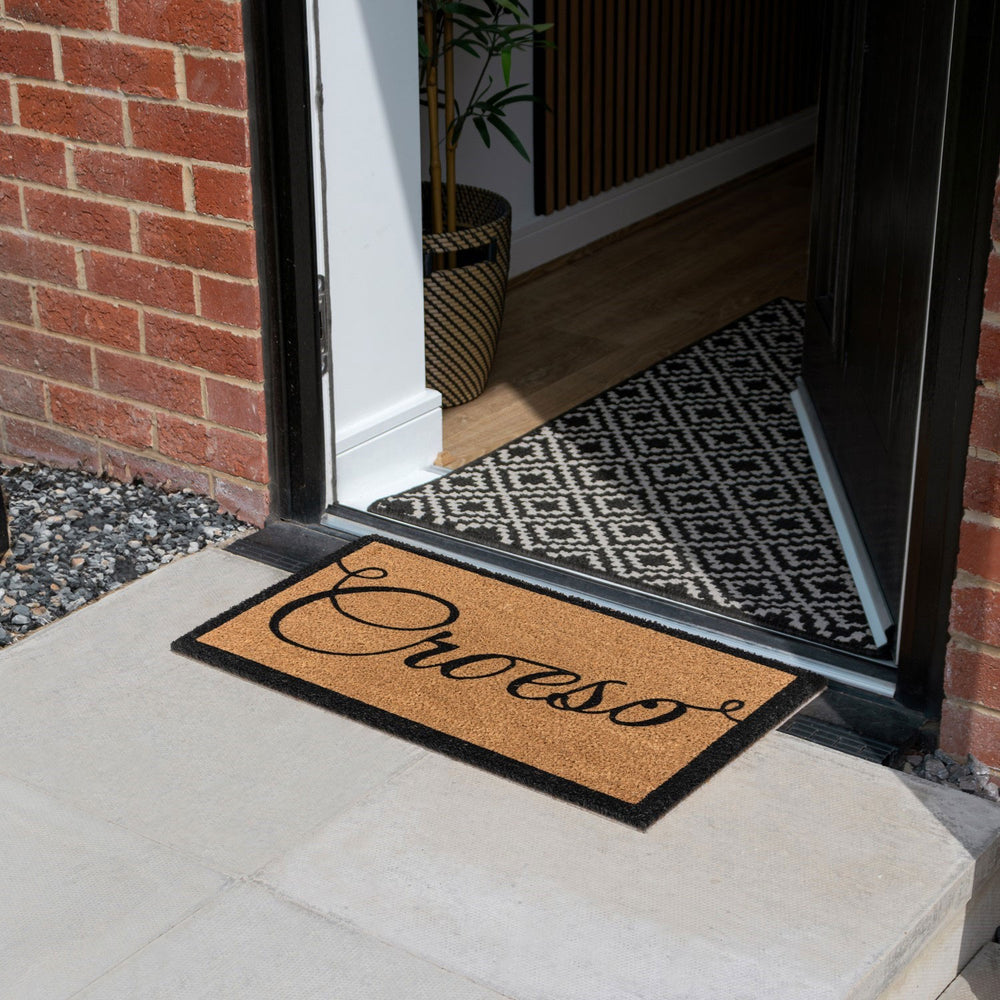 Natural coir doormat featuring the word 'welcome' in Welsh, croeso