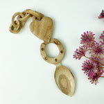 Handcrafted wooden Welsh lovespoon featuring a heart, horseshoe and links