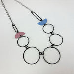 Handmade statement necklace by Deryn featuring black rings and coloured semi circles.