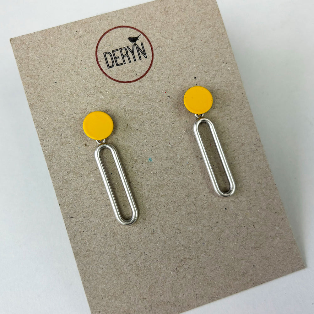 Handmade earrings by Deryn featuring yellow circles and silver ovals