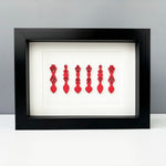 Six hand painted Welsh love spoons mounted in a sleek black box frame.