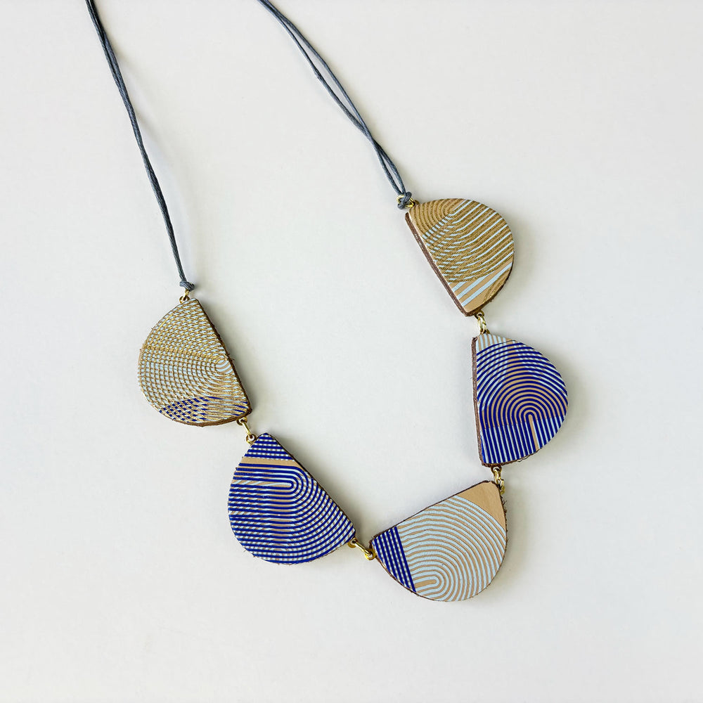 Handmade leather pendant in a geometric pattern by Kay Morgan