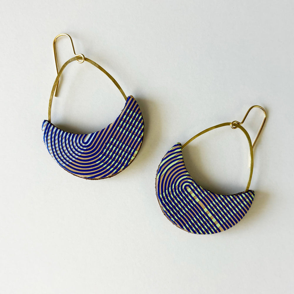 Handmade leather earrings by Kay Morgan with a blue geo pattern