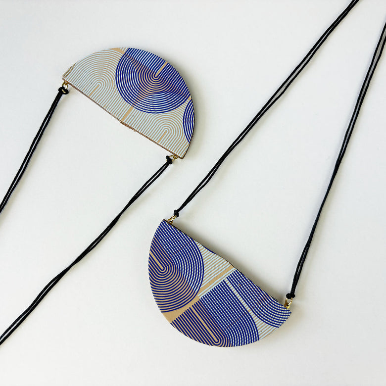 Handmade leather pendant by Kay Morgan with a blue geo pattern