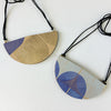 Handmade leather pendant by Kay Morgan with a blue geo pattern