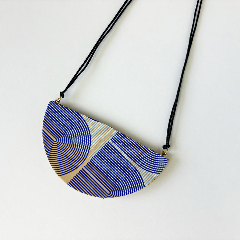 Handmade leather pendant by Kay Morgan with a blue geo pattern