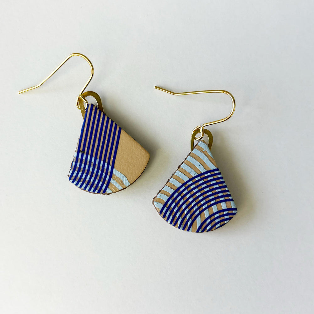 Handmade leather earrings by Kay Morgan with a blue geo pattern