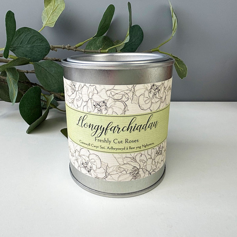 Hand poured soy wax candle presented in a resealable paint pot style tin featuring the word 'congratulations' in Welsh 'llongyfarchiadau'.