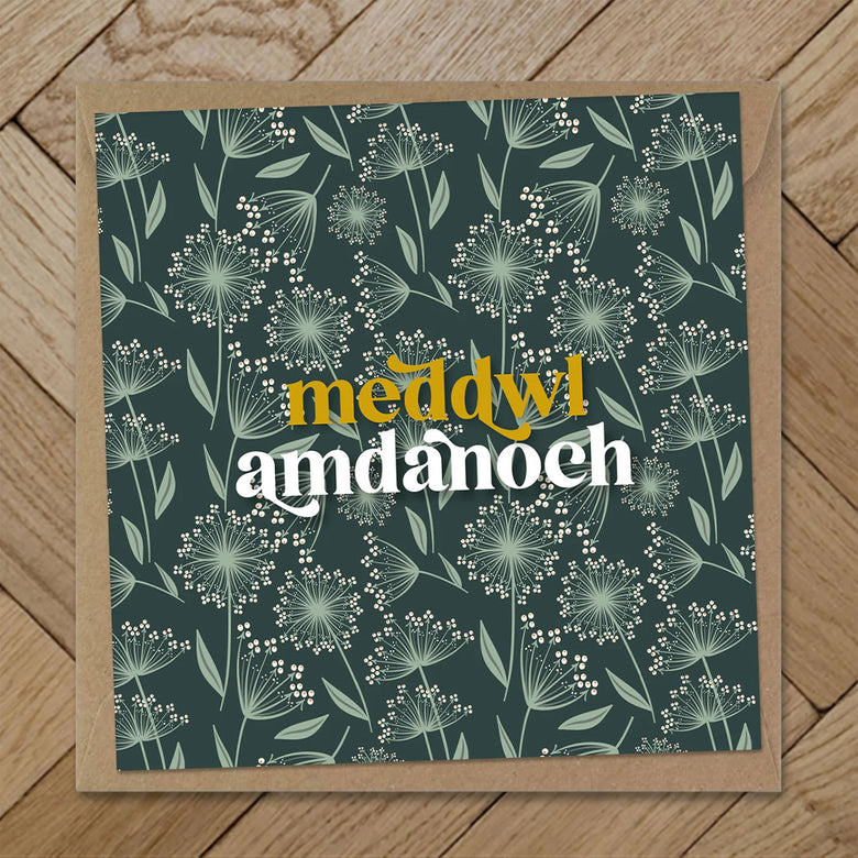 Welsh sympathy card with a green floral deisgn and the words meddwl amdnaoch