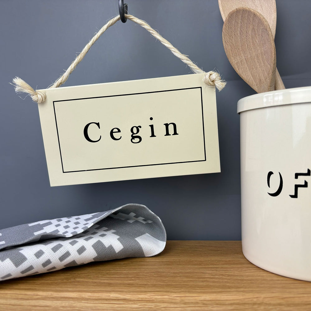 Cream enamel Welsh hanging kitchen sign featuring the word Cegin