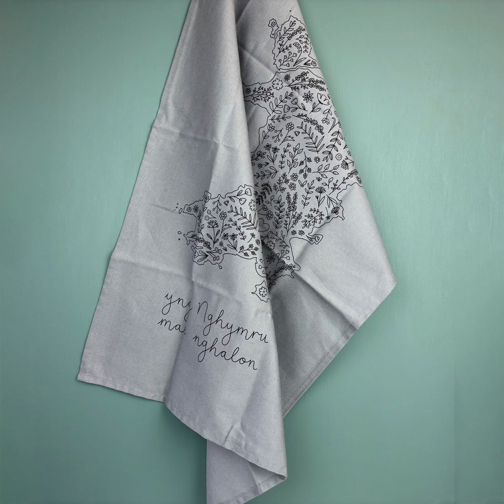Grey tea towel with floral map of Wales
