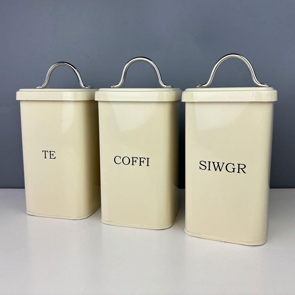 Vintage style enamel canisters featuring the words tea, coffee, sugar in Welsh