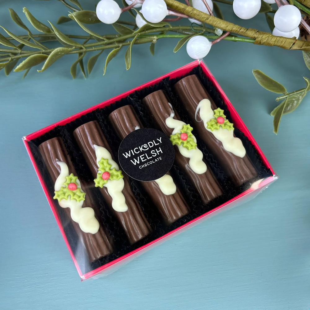 Chocolate yule logs with handcrafted sugar holly by Wickedly Welsh
