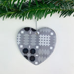 Ceramic heart shaped Christmas decoration hung on tree