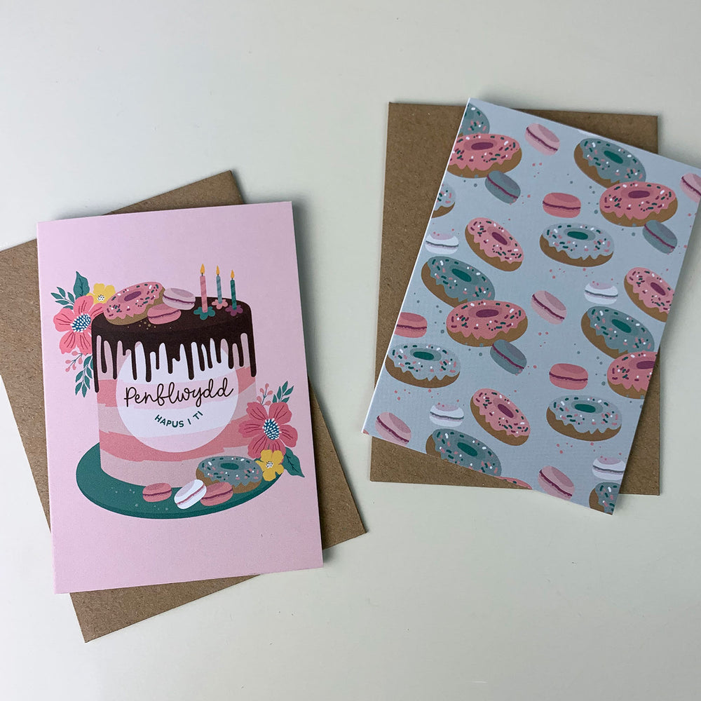 2 Welsh birthday cards, one with a cake the other with doughnuts