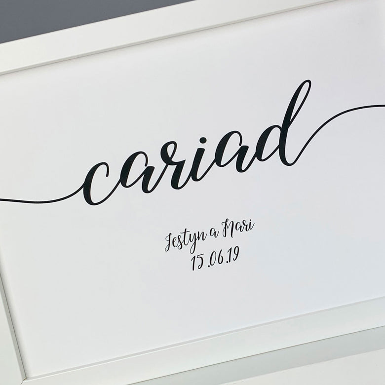 Closeup of personalised gift for couples framed print with the word 'love' in Welsh.