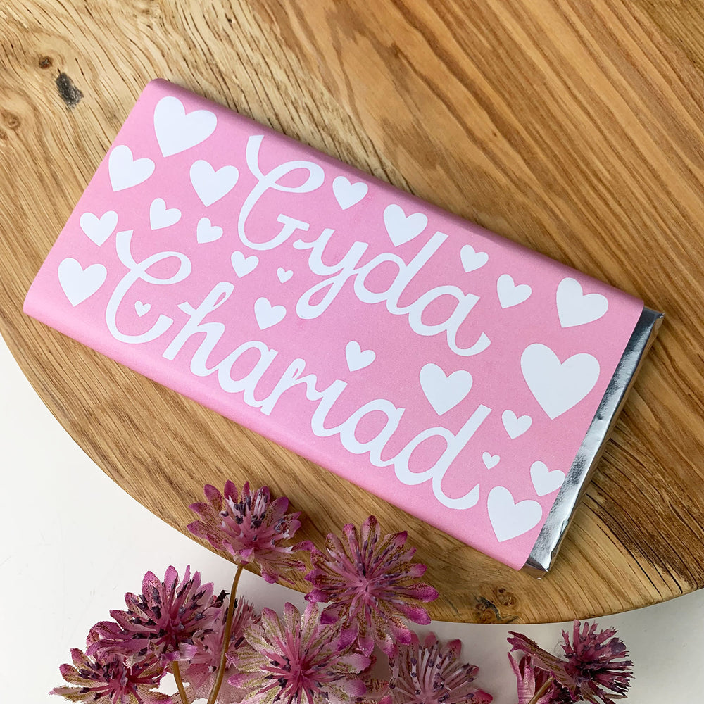 Welsh chocolate bar wrapped in pink with 'with love' written in Welsh